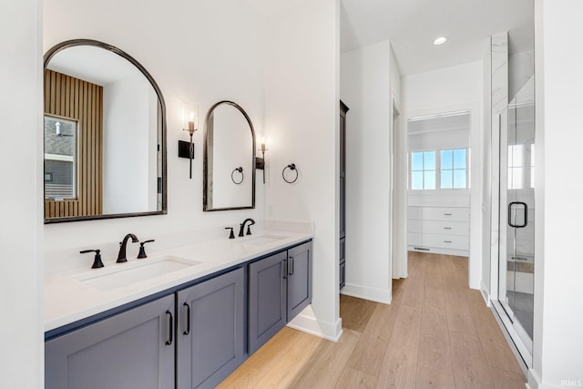 12279 Blue Jay Trl, Fort Wayne, IN 46814 - bathroom with double vanity, wood finished floors, a shower stall, and recessed lighting