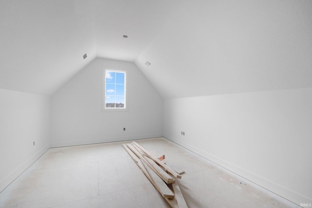 additional living space featuring lofted ceiling