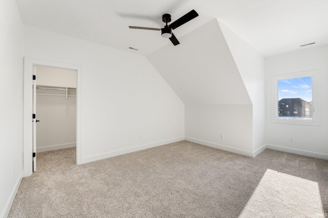 bonus room featuring vaulted ceiling, light carpet, and ceiling fan