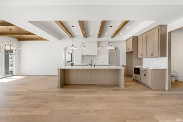 12279 Blue Jay Trl, Fort Wayne, IN 46814 - kitchen featuring a chandelier, backsplash, beamed ceiling, light countertops, and a large island with sink