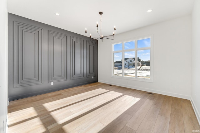 12279 Blue Jay Trl, Fort Wayne, IN 46814 - empty room with a chandelier, light wood-style flooring, and recessed lighting
