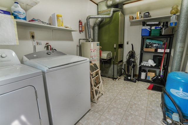 laundry area featuring water heater, washer and dryer, and light tile patterned floors