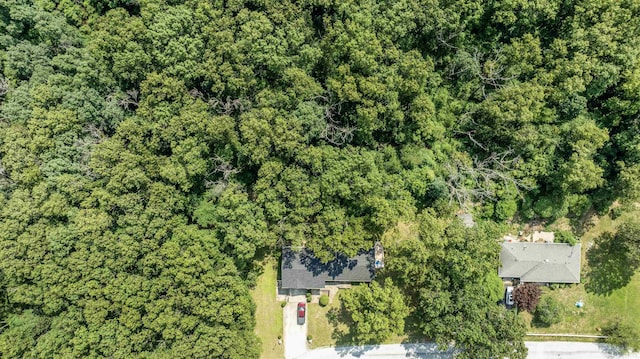 drone / aerial view featuring a wooded view