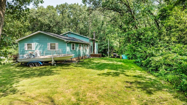 rear view of house featuring a lawn