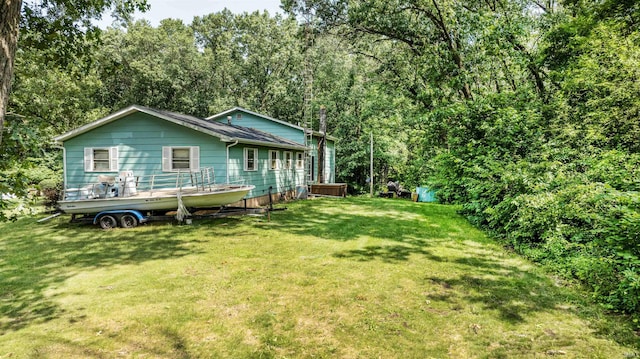 rear view of property with a lawn