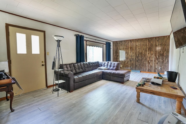 living room featuring hardwood / wood-style floors and wooden walls