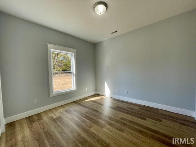 unfurnished room with dark hardwood / wood-style floors