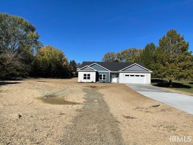 ranch-style house featuring driveway and an attached garage