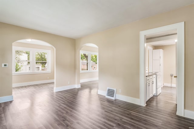 unfurnished room featuring dark hardwood / wood-style floors