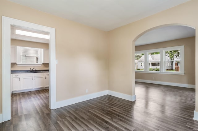 unfurnished room with sink and dark hardwood / wood-style floors