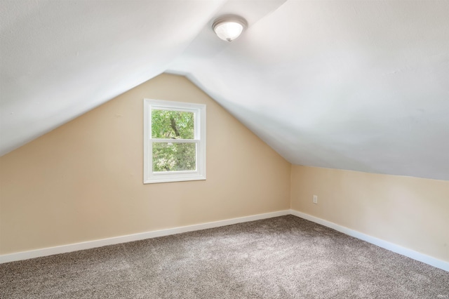 bonus room featuring vaulted ceiling and carpet flooring