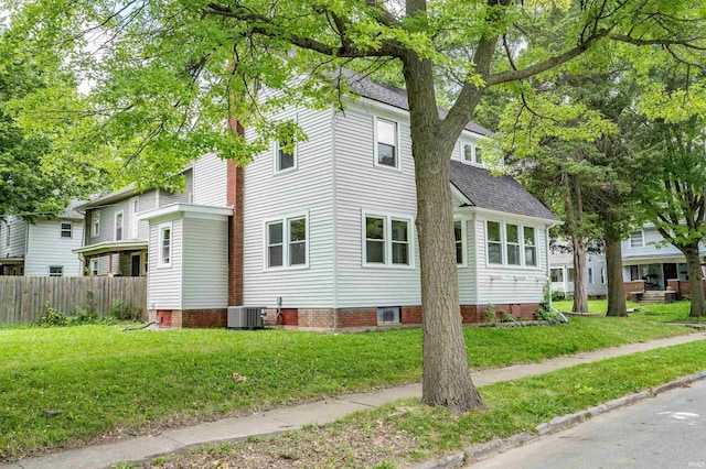 view of home's exterior with a yard and central air condition unit