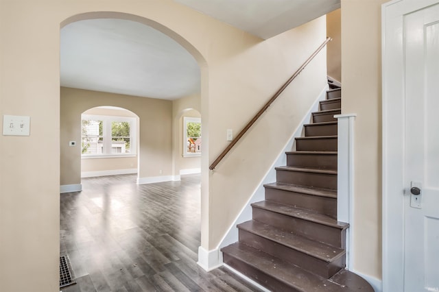 staircase featuring wood-type flooring