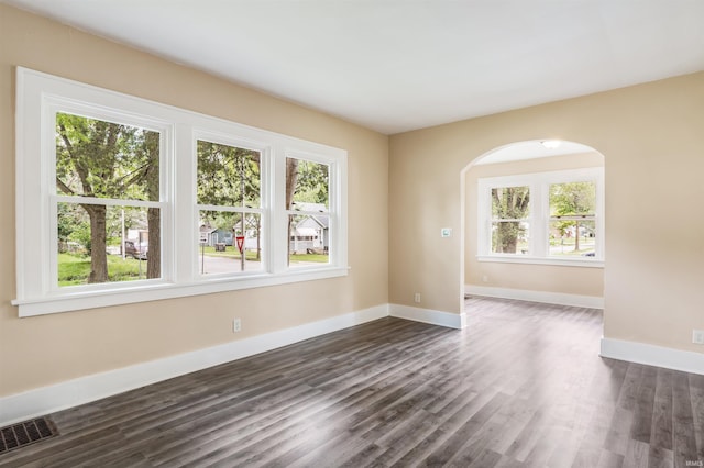 unfurnished room featuring dark hardwood / wood-style flooring