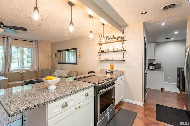 kitchen featuring light stone countertops, stainless steel range with electric cooktop, a kitchen bar, white cabinetry, and hanging light fixtures