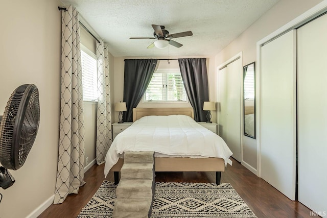 bedroom featuring a textured ceiling, ceiling fan, and dark hardwood / wood-style flooring