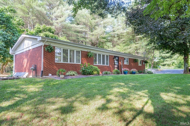 ranch-style home featuring a front yard