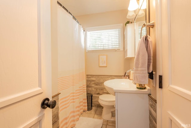 bathroom featuring toilet, tile walls, tile patterned floors, and vanity