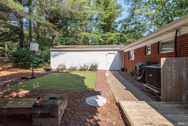 view of yard with a deck, cooling unit, and an outdoor structure