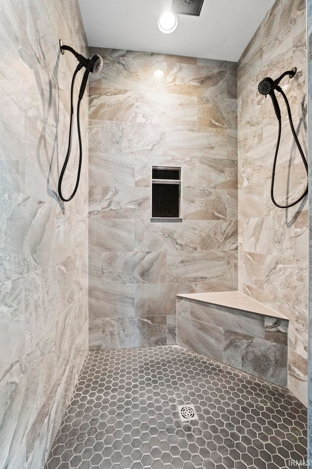 full bath with a tile shower
