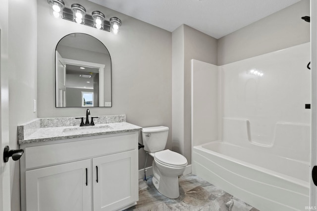 full bathroom with vanity,  shower combination, baseboards, and toilet