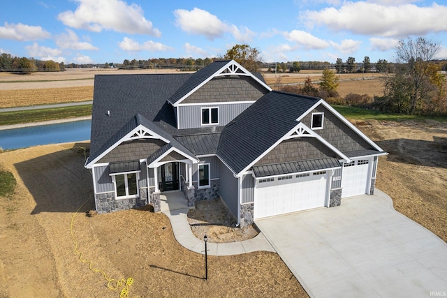 craftsman house with a garage and a rural view