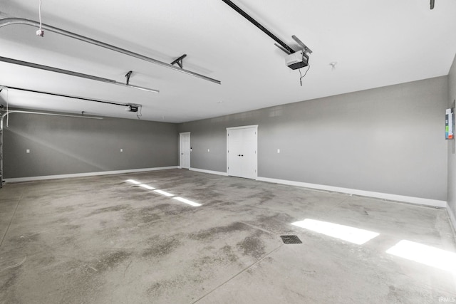 garage with baseboards and a garage door opener