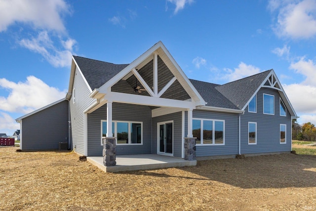 rear view of house with roof with shingles, a ceiling fan, central AC unit, and a patio area