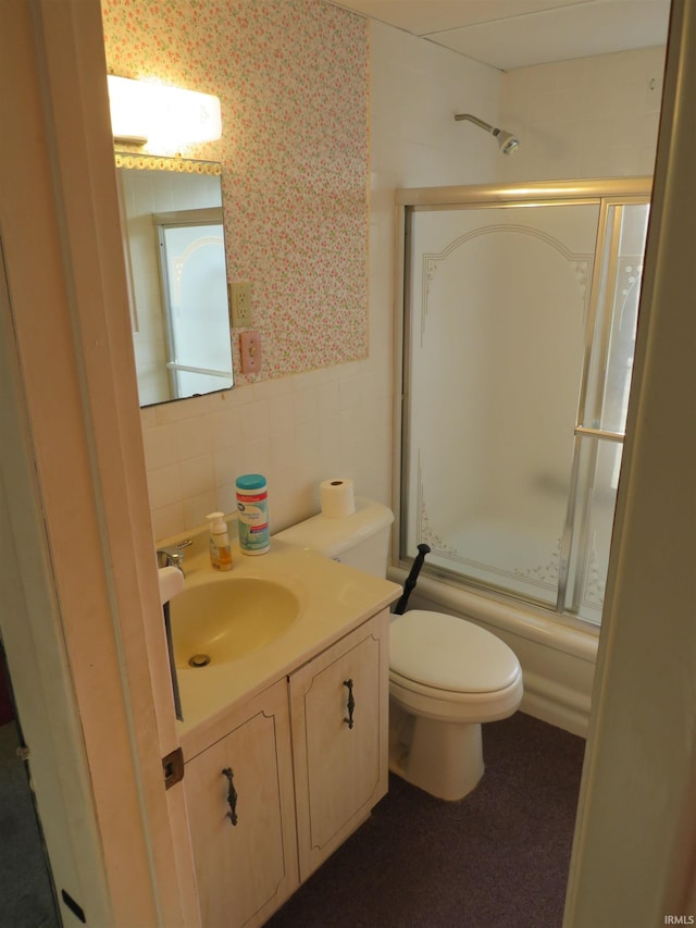 bathroom featuring vanity, backsplash, toilet, and tile walls