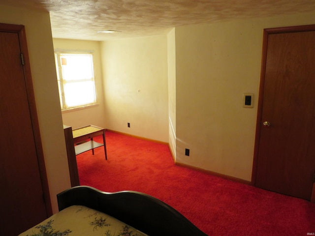 carpeted bedroom featuring a textured ceiling