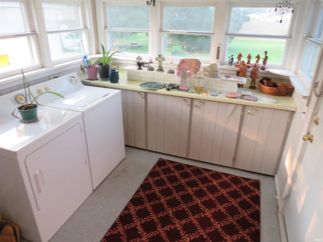 clothes washing area with separate washer and dryer