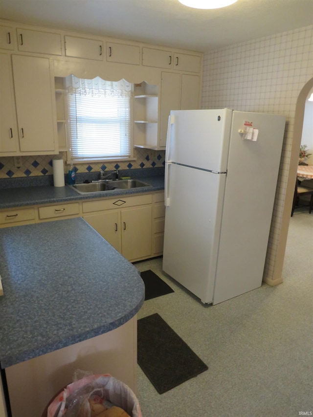 kitchen with sink, white fridge, and tasteful backsplash