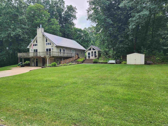 view of front facade featuring a wooden deck, a front yard, and a storage unit