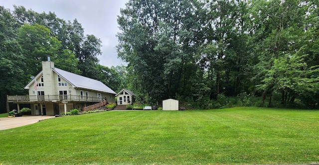 view of yard featuring a wooden deck and a shed