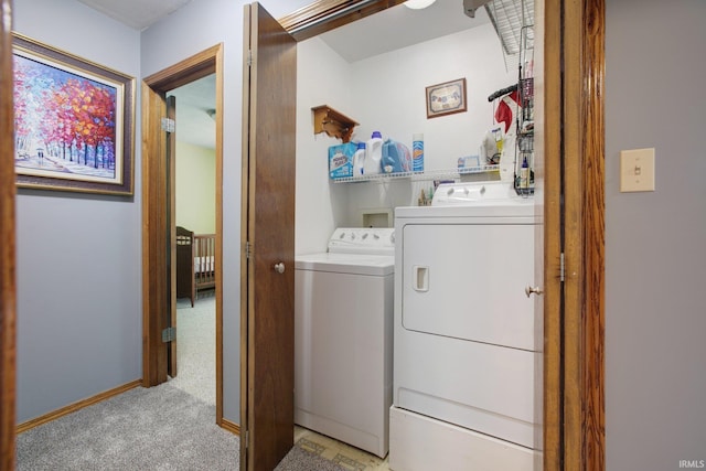 washroom with washer and clothes dryer and light carpet