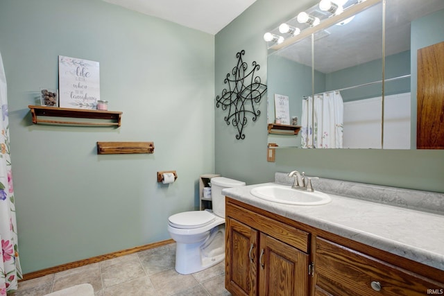 bathroom with tile patterned flooring, vanity, and toilet