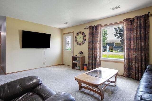 living room with plenty of natural light and light colored carpet