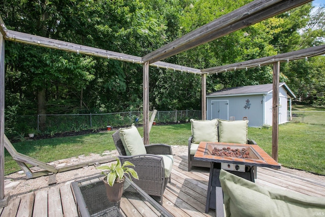 wooden terrace featuring a lawn and a storage shed