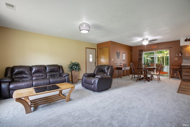 living room with carpet and ceiling fan