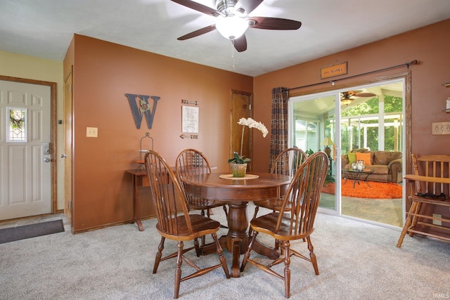 carpeted dining area featuring ceiling fan