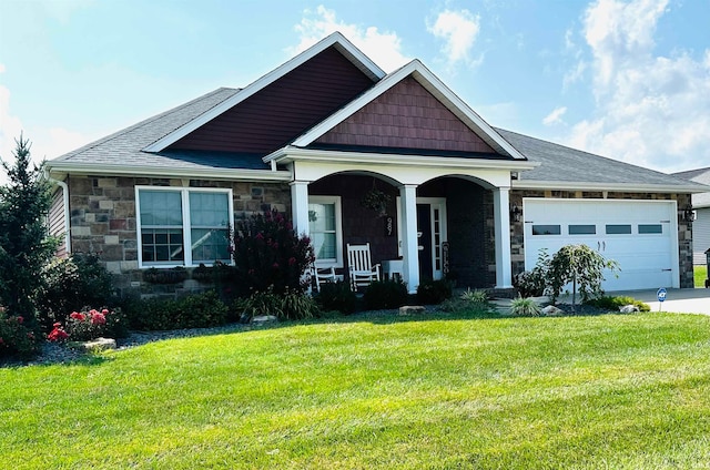 craftsman house with covered porch, a garage, and a front yard