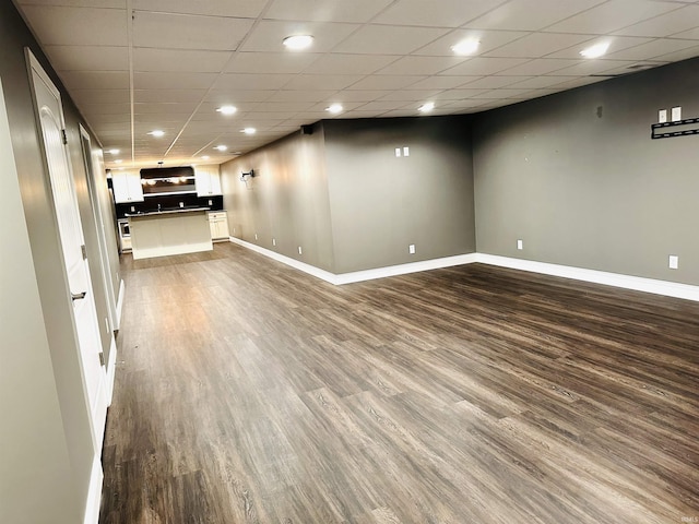 interior space featuring wood-type flooring and a paneled ceiling