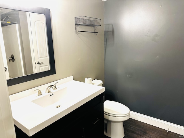 bathroom featuring vanity, hardwood / wood-style flooring, and toilet