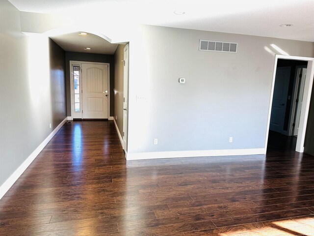 hall featuring dark wood-type flooring and a textured ceiling