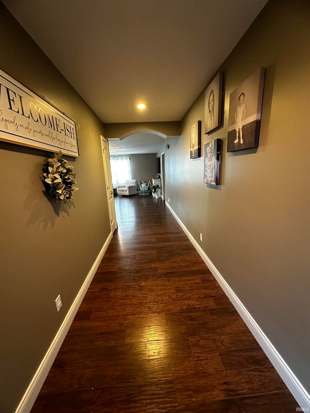 hallway with dark hardwood / wood-style floors