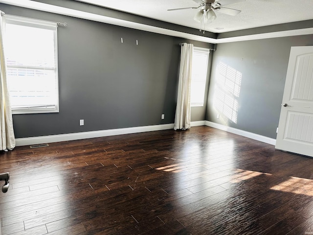 spare room featuring ceiling fan and dark hardwood / wood-style flooring