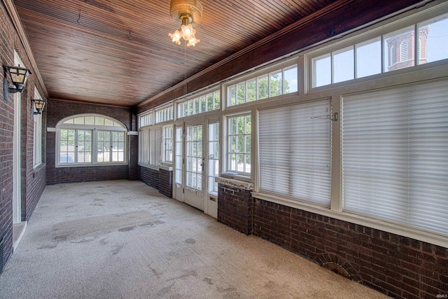 unfurnished sunroom with wooden ceiling