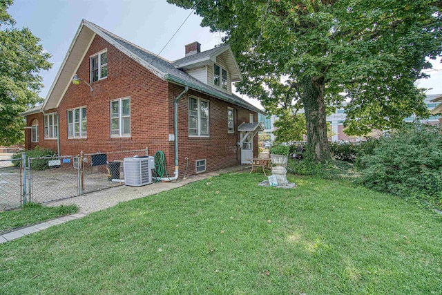 view of side of home with a yard and cooling unit