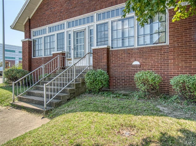 doorway to property featuring a yard