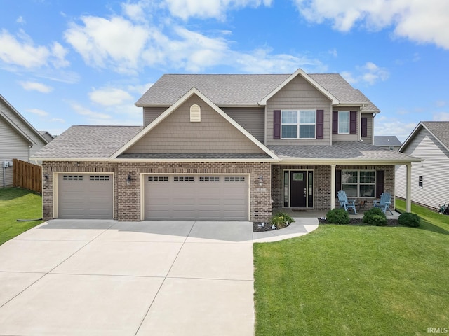 craftsman inspired home featuring a porch, a garage, and a front yard